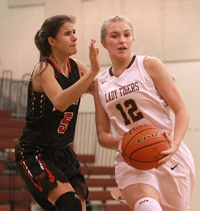  Dripping Springs sophomore shooting guard Julia Graham drives the lane past a Lake Travis High defender during a game played in the Drip Classic tournament in November. (photo by Moses Leos III)