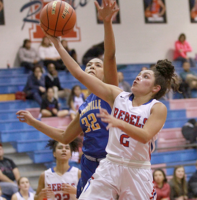 Hays High junior Gabby Bosquez (2) goes for a layup beyond a Pflugerville Panther’s reach. (photo by Moses Leos III)