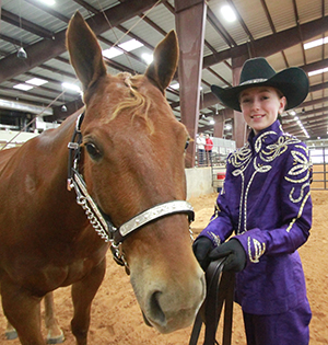 Wimberley resident Ashley Wortham poses with her show horse prior to competing in the Hays County Livestock Show and Expo horse show at the Dripping Springs Ranch Park Jan. 14. The annual horse show kicked off the livestock show, which will take place Jan. 24-26 in Dripping Springs.  (photo by Moses Leos III)