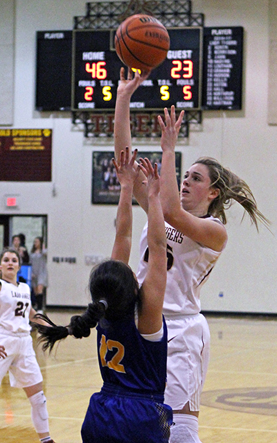 With a 46-23 lead early in the fourth period Dripping Springs’ freshman Sarah Nading, who was moved up to varsity last week, goes up and over the out-stretched arms of Cici Castillo (12) defending for Alamo Heights. (photo by Wayland D. Clark, wfotos.com)