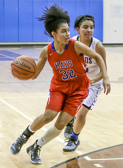 Hays Rebel senior guard Breajee McMillian (32) readies to drive into the paint during the team’s district contest against the Lehman Lobos at the Lobo Den Jan. 6. (photo by Moses Leos III)