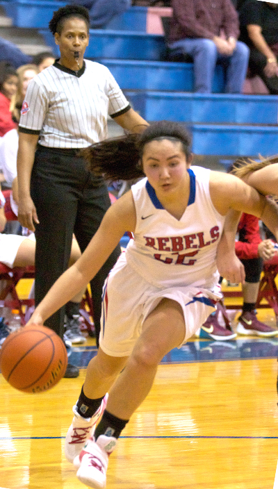 Hays Rebel senior guard Choon Hee Chae (22) pushes against a Lake Travis Cavalier defender as she attempts to drive the baseline Tuesday at Bales Gym. (photo by Moses Leos III)
