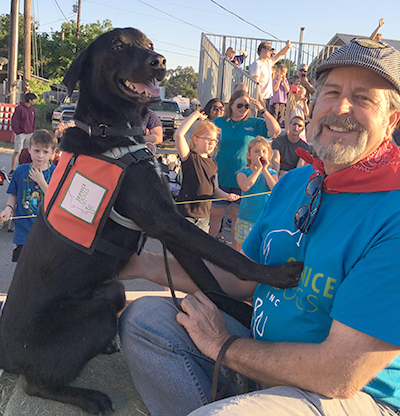 Director of Training Al Kordowski and service dog Anakin on the Service Dogs, Inc. float at the 2016 Founders Day Parade. (photo courtesy of Service Dogs, Inc.)