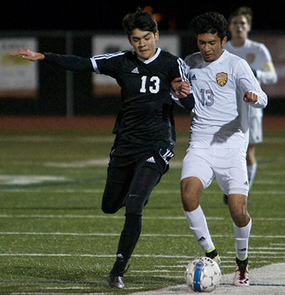  Dripping Springs High’s Humberto Gonzales (right) battles with a Seguin Matador defender for the ball near the sideline Friday in Dripping Springs.  (photo by Moses Leos III)