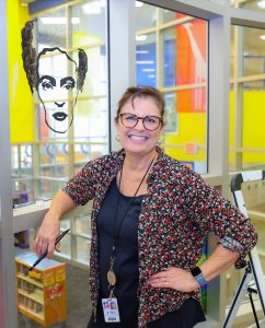 Teacher paints mural at Pfluger Elementary